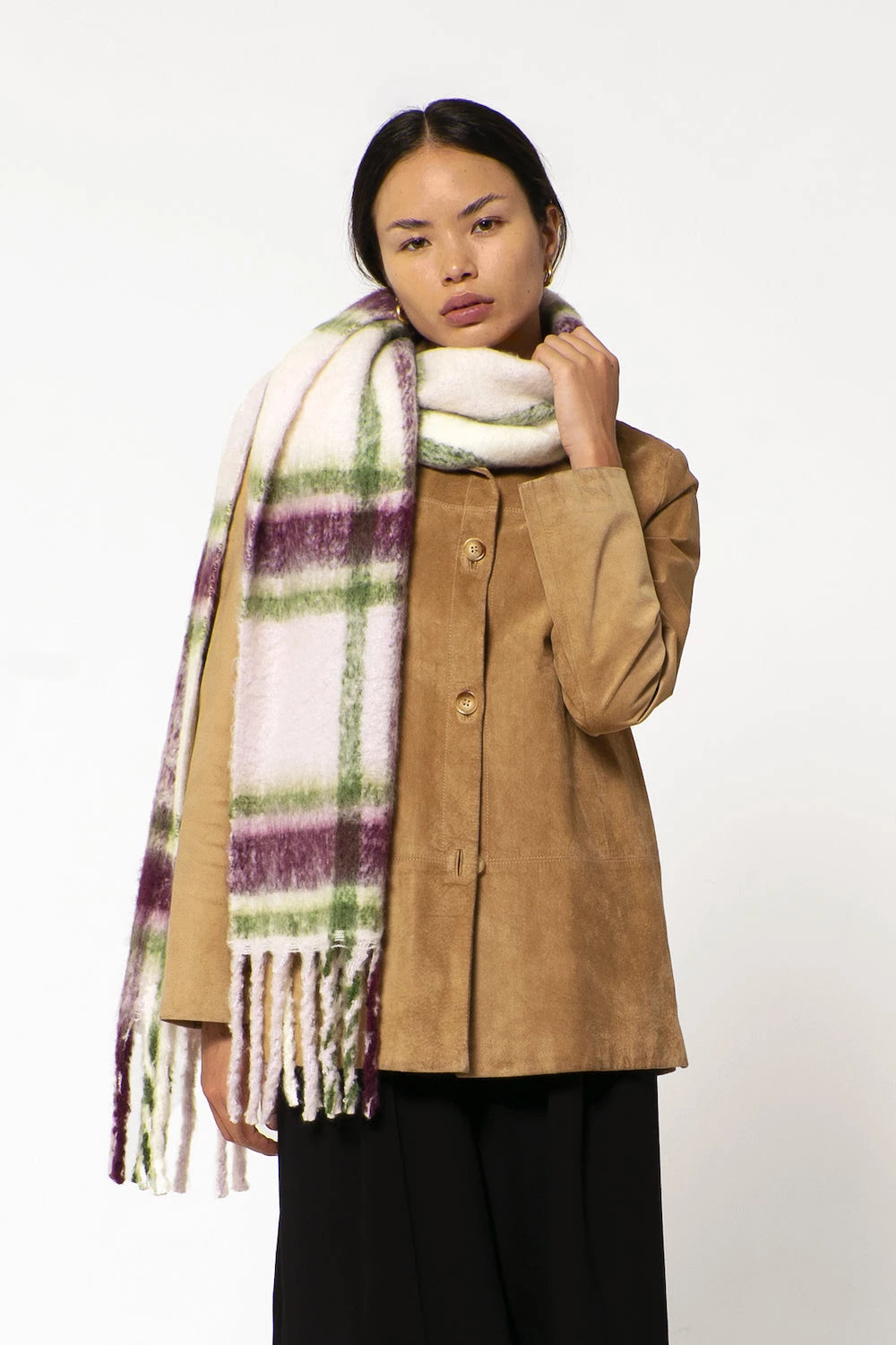 woman wearing oversized plaid scarf
