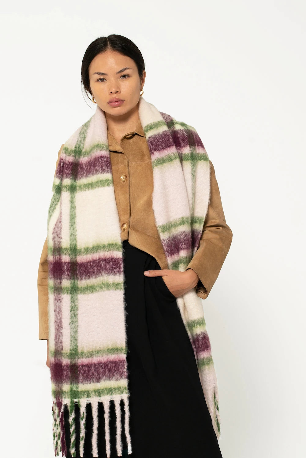 woman wearing oversized plaid scarf