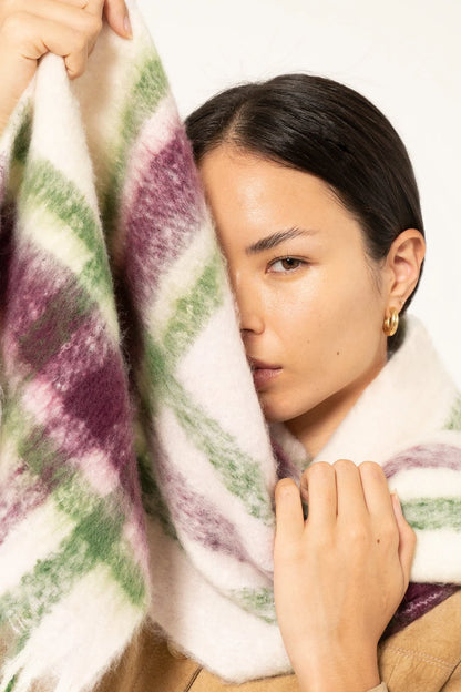 close up of woman wearing oversized plaid scarf with soft fluffy material